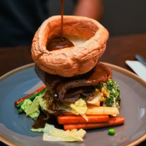 Close-up of Sunday roast with giant Yorkshire pudding and gravy