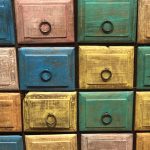 Close up of colourful square, rustic drawers