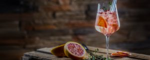 Fruity cocktail against a rustic brick and wood backround