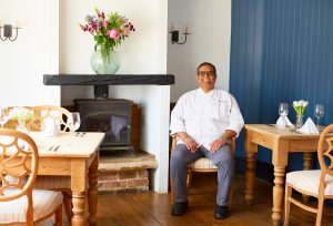 Chef Krishna sitting in a bright, modern cosy room